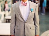 a dove grey blazer, a striped shirt, a pink polka dot bow tie and a turquoise fabric flower boutonniere for a pretty and bold look