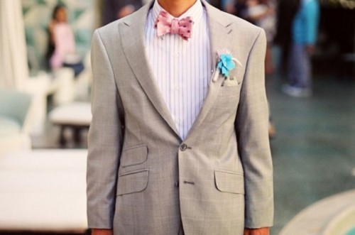 a dove grey blazer, a striped shirt, a pink polka dot bow tie and a turquoise fabric flower boutonniere for a pretty and bold look