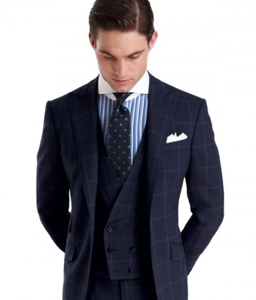 a sophisticated checked navy groom's suit, a blue and white striped shirt, a navy and blue polka dot tie for a refined look