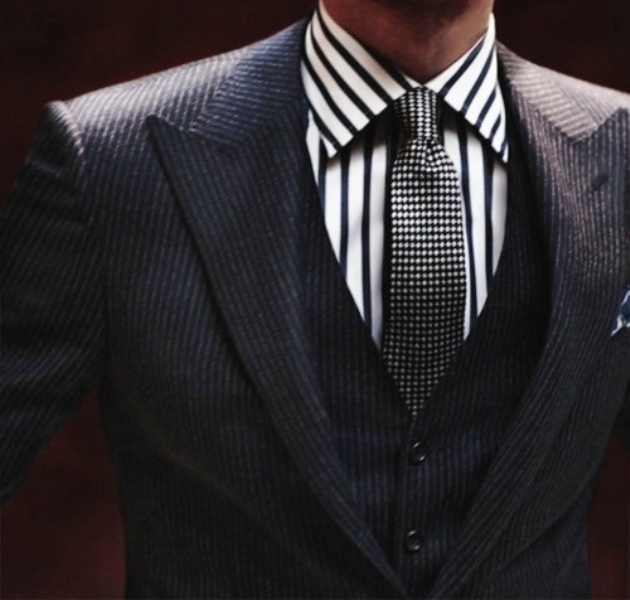 a stylish groom's look with a striped shirt, a checked tie and a grey three piece triped suit