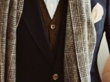 a beautiful and elegant groom’s outfit with a blue checked shirt, a brown cardigan, a navy blazer, a mustard polka dot bow tie and a grey checked scarf