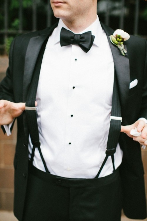 a classic black tux worn with black suspdenders is a stylish idea for a modern and refined groom