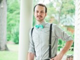 black pants, black suspenders, a grey shirt and a turquoise bow tie for a stylish groom’s look with a touch of color