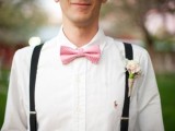 a white shirt, black suspenders, a pink bow tie and a blush floral boutonniere for an elegant summer groom’s look