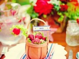a cute mini basket with strawberries and greenery is a lovely wedding favors and a cool way to top your place setting at a summer wedding