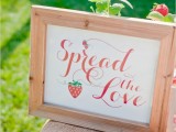 a cute sign with calligraphy and a strawberry is a lovely wedding decoration for any non-formal wedding