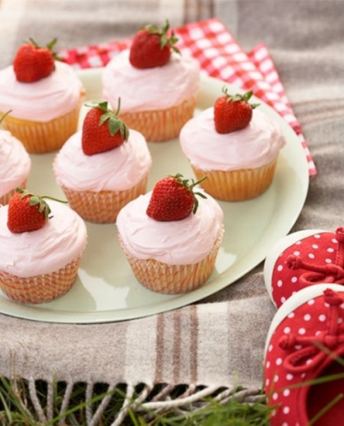 frosted cupcakes topped with strawberries are amazing for weddings - they can fit any garden wedding or just a summer one