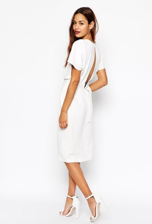 a plain white midi A-line dress with white short sleeves, a cutout back and a high neckline plus white heels for a modern or minimalist bride-to-be