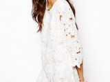 a white boho lace A-line mini dress with short sleeves and a high neckline is a lovely idea for a boho bride-to-be