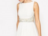 a white sleeveless A-line mini dress with a high neckline, gold beading and a pleated skirt is a lovely and catchy idea that is comfy in wearing