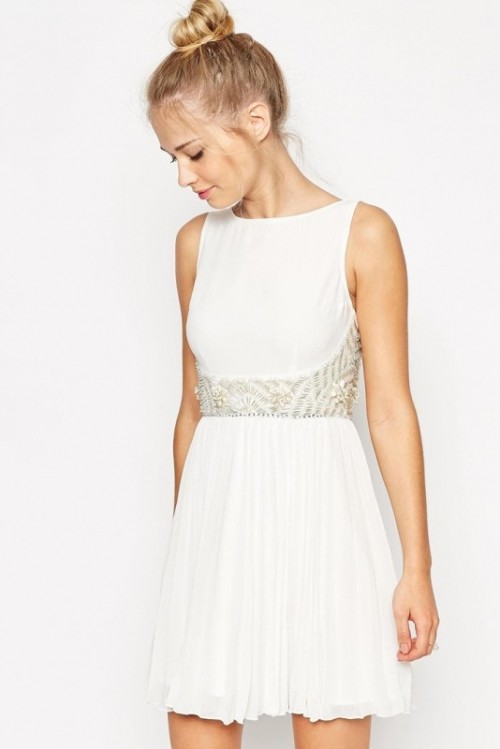 a white sleeveless A-line mini dress with a high neckline, gold beading and a pleated skirt is a lovely and catchy idea that is comfy in wearing