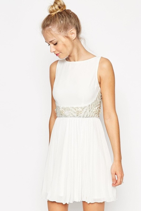 A white sleeveless A line mini dress with a high neckline, gold beading and a pleated skirt is a lovely and catchy idea that is comfy in wearing