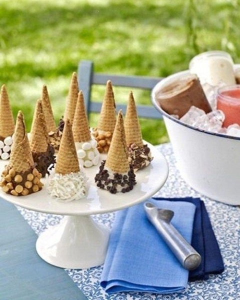 a stand with ice cream cones with various edible decor and a large bowl with ice and ice cream in glass jars are great for a small wedding outdoors