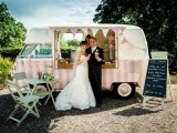 a small vintage ice cream van, with a chalkboard menu and pastel-colored folding furniture next to it, to have a seat and enjoy ice cream