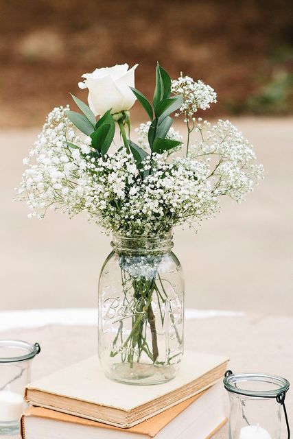 vintage books with a white floral arrangement on top will always work for a rustic wedding or a vintage one