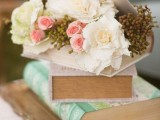 a stack of vintage books with fresh blooms inside is a gorgeous idea for a vintage or shabby chic wedding