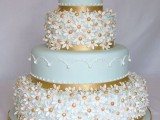 a beautiful mint green wedding cake with patterned tiers and floral ones plus gold decor is a statement idea