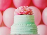 a romantic ombre mint green wedding cake topped with bold pink blooms for a summer wedding