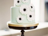 a romantic mint green wedding cake decorated with white sugar anemones for a spring or summer weddnig