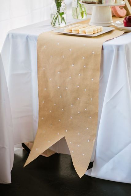 a polka dot kraft paper table runner looks really cute and lovely and you can DIY it in a couple of minutes