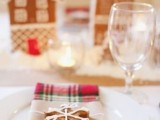 a winter wedding place setting with a plain napkina nd a gingerbread snowflake-shaped cookie that accents the place setting and embraces the season