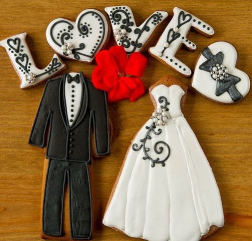 an assortment of black, white and red wedding gingerbread cookies shaped in various fun shapes will make lovely favors or can be served on your wedding table