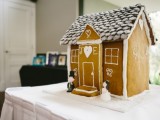 a lovely gingerbread house with decor and glazing and monograms can be created as decor or food for your Christmas wedding