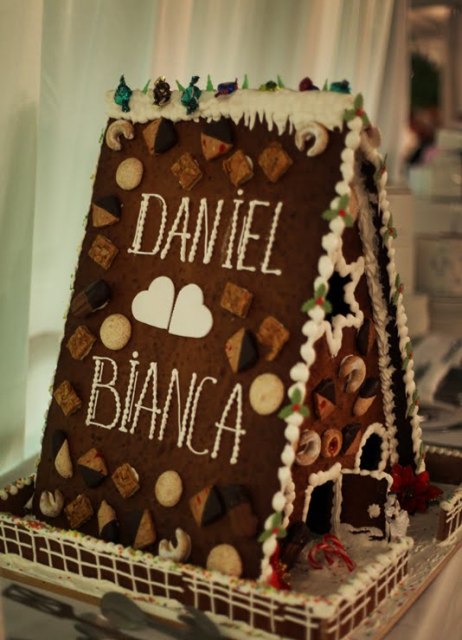 a gorgeous teepee-shaped gingerbread house with glazing and decor and names of the couple is an amazing idea for a winter or Christmas wedding, this is gorgeous homey decor