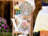 a ladder decorated with doilies, letters and fresh flower arrangements is a very romantic wedding decoration
