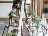 a whitewashed vintage ladder with candles, wildflowers, books is a chic and refined decor idea