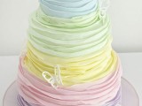 a bright pastel wedding cake decorated with sugar butterflies is a lovely and bold idea to go for – looks very unusual