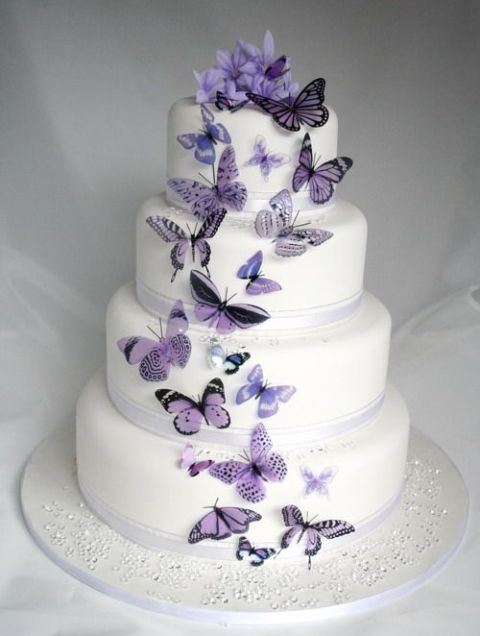 a white wedding cake with ribbons and purple and lilac bitterflies looks very tender, soft and ethereal, it's real charm and love