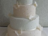 a pastel wedding cake with polka dots, ribbons and sugar butterflies is a lovely and romantic idea to go for