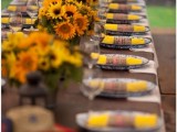 a rustic fall rehearsal dinner styled with sunflowers, candle lanterns and plaid napkins is lovely and very welcoming
