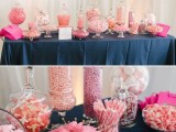 a table with a navy tablecloth and pink candies in jars is highlighting the wedding color scheme
