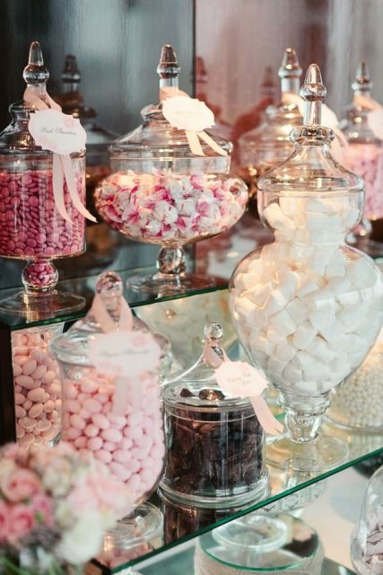 a mirror candy bar done with lots of jars with candies will be a nice fit for a glam or modern wedding