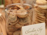 a cookie bar with large jars filled with cookies plus tongs to grab the sweets comfortably