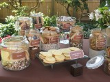 a simple cookie bar with lots of open jars, tags and bows plus a glass stand with cookies