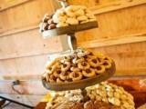 a simple wooden cookie stand with various types of them is ideal for a rustic wedding