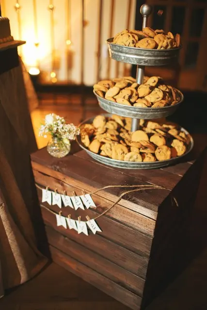 a rustic cookie bar with a stained wooden chest and a metal cookie stand plus a banner