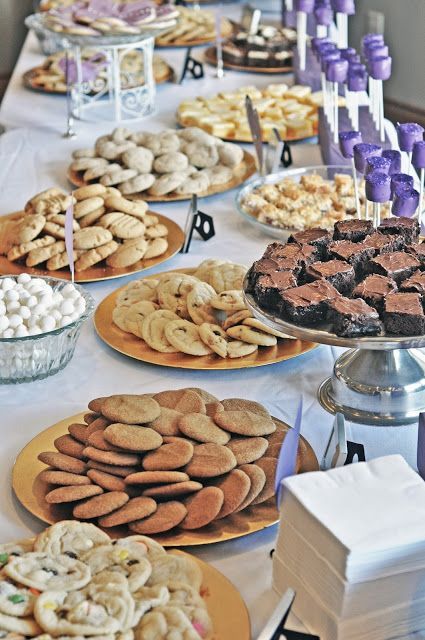a simple cookie table with metallic plates with cookies, sweets and cake pops to please everyone