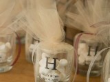 wedding favors of glasses with candles covered up with white tulle is a simple DIY idea