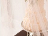 display your wedding cake on a vintage table with tulel curtains around to let your guests see it