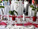 red tulle table runners and red wedding centerpieces make the decor bolder