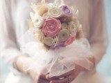 a fake bloom wedding bouquet with a white tulle wrap is eco-friendly and cool