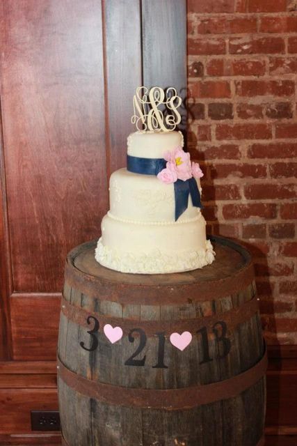 a wedding cake stand of a wine barrel is a lovely idea for a vineyard or rustic wedding