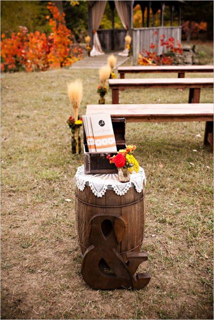 rustic wedding ceremony space decor with a barrel, a doily, bright blooms and an ampersand is a very cool idea