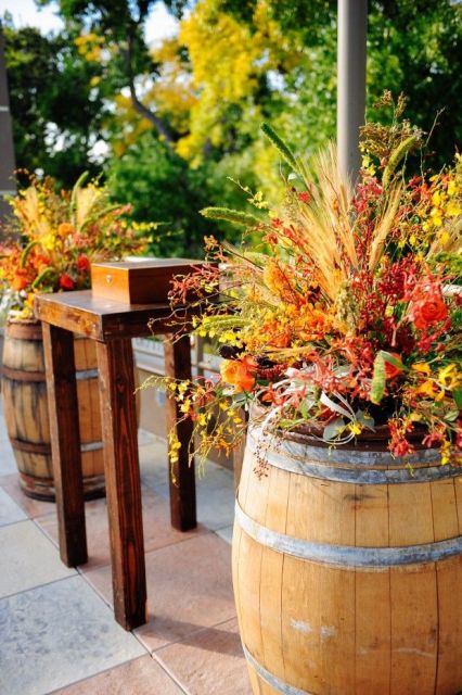 wine barrels as stands for floral arrangements will decorate botht he venue and the wedding ceremony space and make it brighter