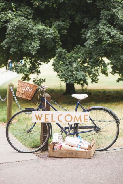 a bike with a sign and a basket, a box with wedding favors is a lovely wedding decoration for an outdoor spring or summer wedding