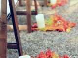 bright fall leaf arrangements and pillar candles are great to line up a fall wedding aisle instead of blooms